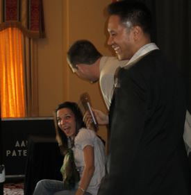 Aaron on stage with two audience volunteers
