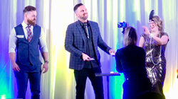 An spectator laughs hysterically as magician Aaron Paterson performs amazing magic.